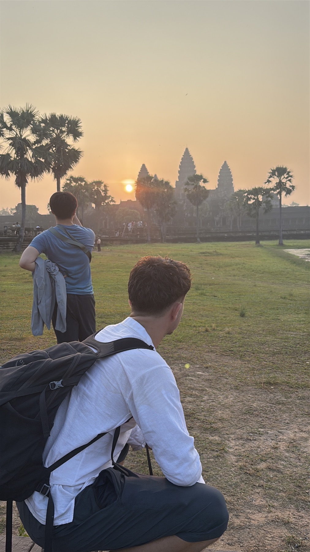 Ollie arriving at Angkor Wat at sunrise with his travel backpack
